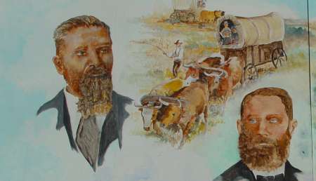 Two bearded men in formal attire are depicted alongside a scene of oxen pulling a covered wagon, with a man guiding them across a rural landscape.