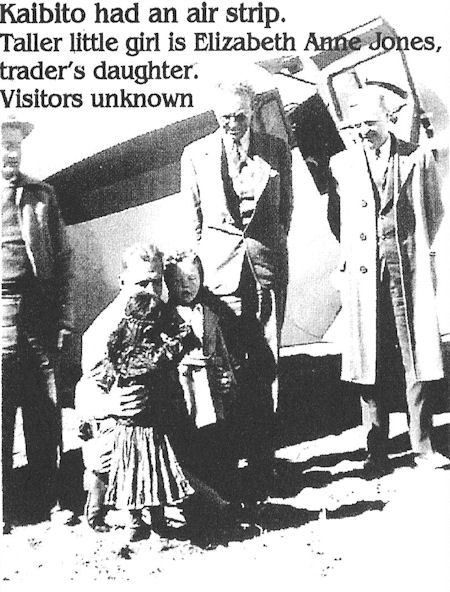 Black and white photo of five people, including a child identified as Elizabeth Anne Jones, standing in front of a small aircraft; other visitors are unidentified.