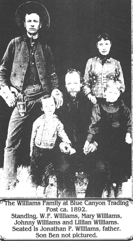 A black and white photo of the Williams family at Blue Canyon Trading Post, circa 1892. Four adults and two children pose; an inscription identifies them and notes one son is not pictured.