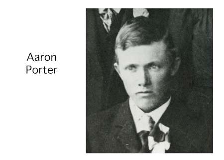 Black and white portrait of a young man in a suit with a boutonnière, identified as Aaron Porter by adjacent text.