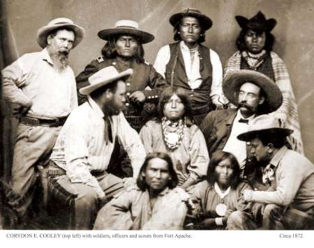 Black-and-white photo of a group of men, including soldiers, officers, and scouts from Fort Apache, posed together, circa 1872.