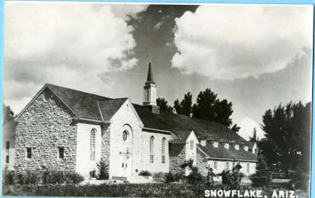 Black and white photo of a stone church building with a steeple, surrounded by trees, labeled "Snowflake, Ariz." at the bottom right.